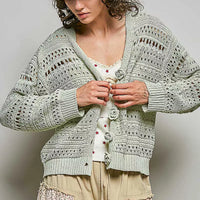 Light gray open-knit cardigan with button front and flower details, long sleeves
