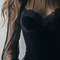 Black velvet corset blouse close-up with lace-trim bust and sheer sleeve panels
