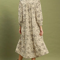 Beige botanical-print tiered midi dress back view with long sleeves