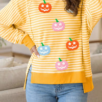 Yellow striped Halloween waffle-knit pullover with pumpkin face graphic, crew neck