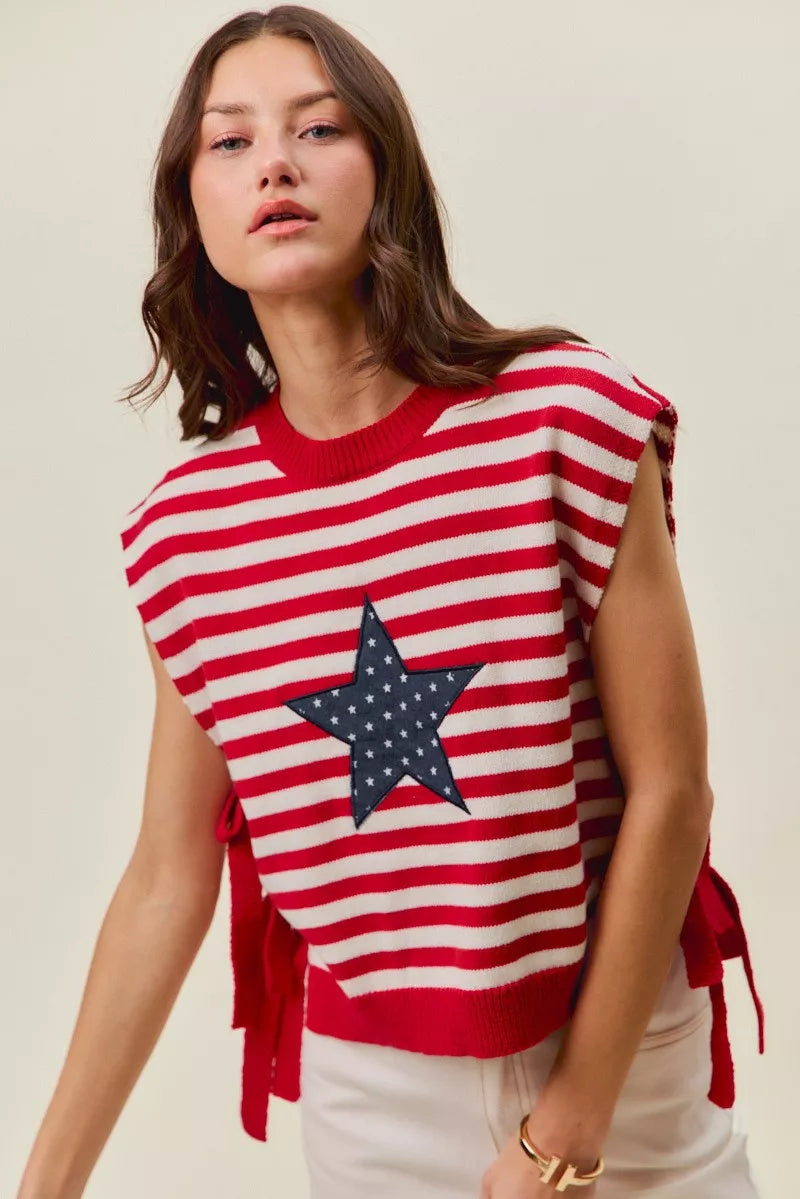 Red and ivory striped knit vest top with navy star patch at front, side tie accents