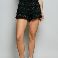 Black ruffled shorts with layered fabric tiers and elastic waist