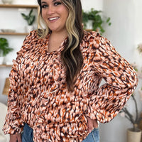 Caramel printed V-neck balloon-sleeve tunic with ruffle trim and button front