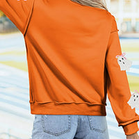 Orange mock neck sweatshirt, back view, ghost appliques and ribbed hem