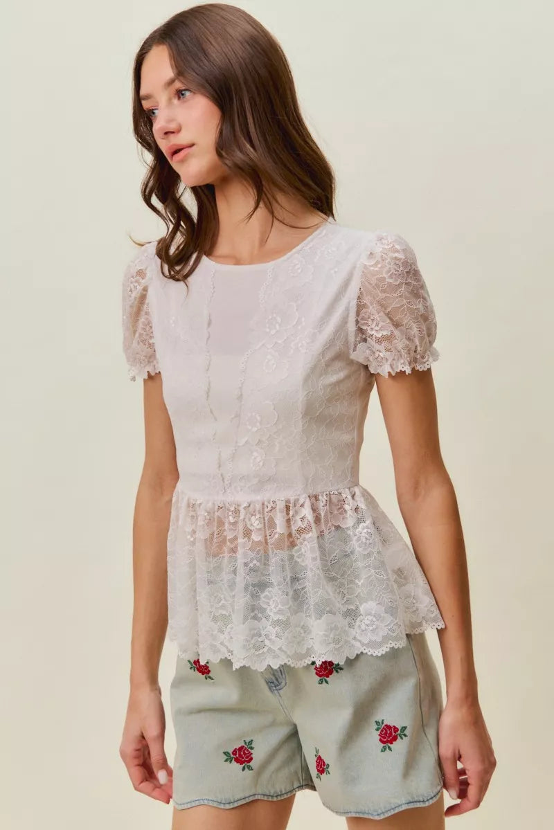 Roses embroidered denim shorts on model with lace top pairing