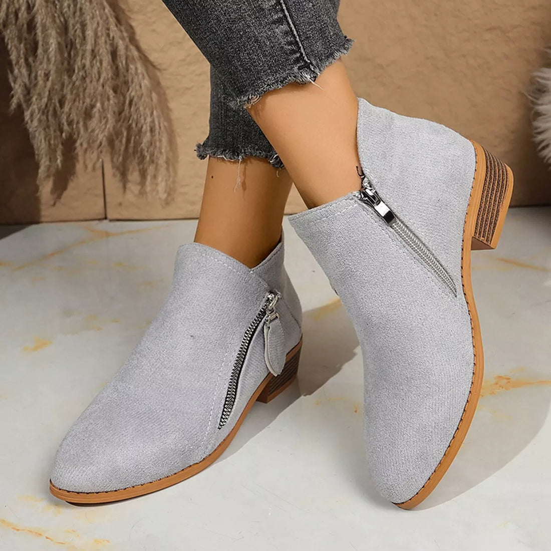 Light gray suede point-toe block heel ankle boots with side zipper