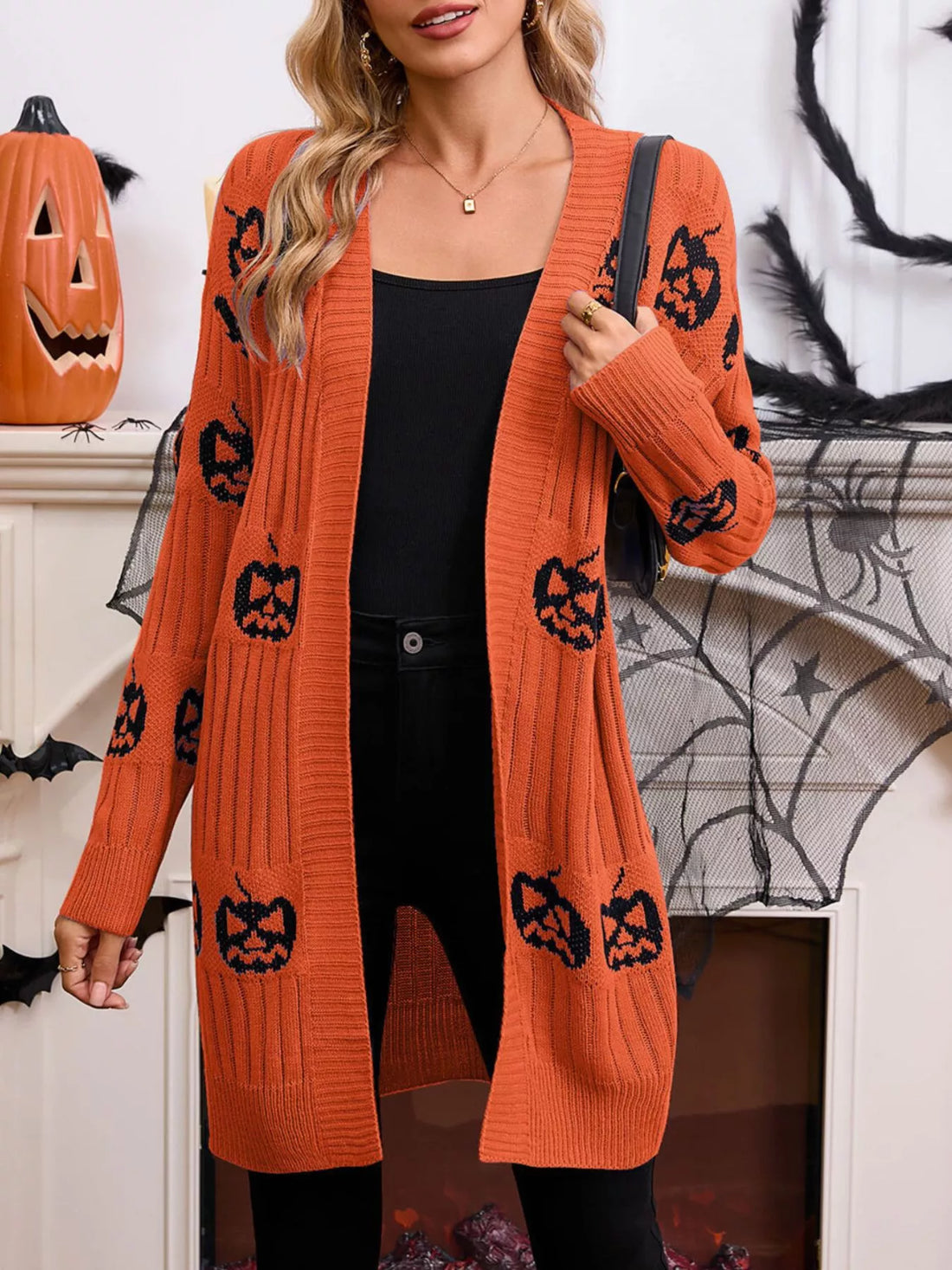 Orange open-front knit cardigan with black jack-o&