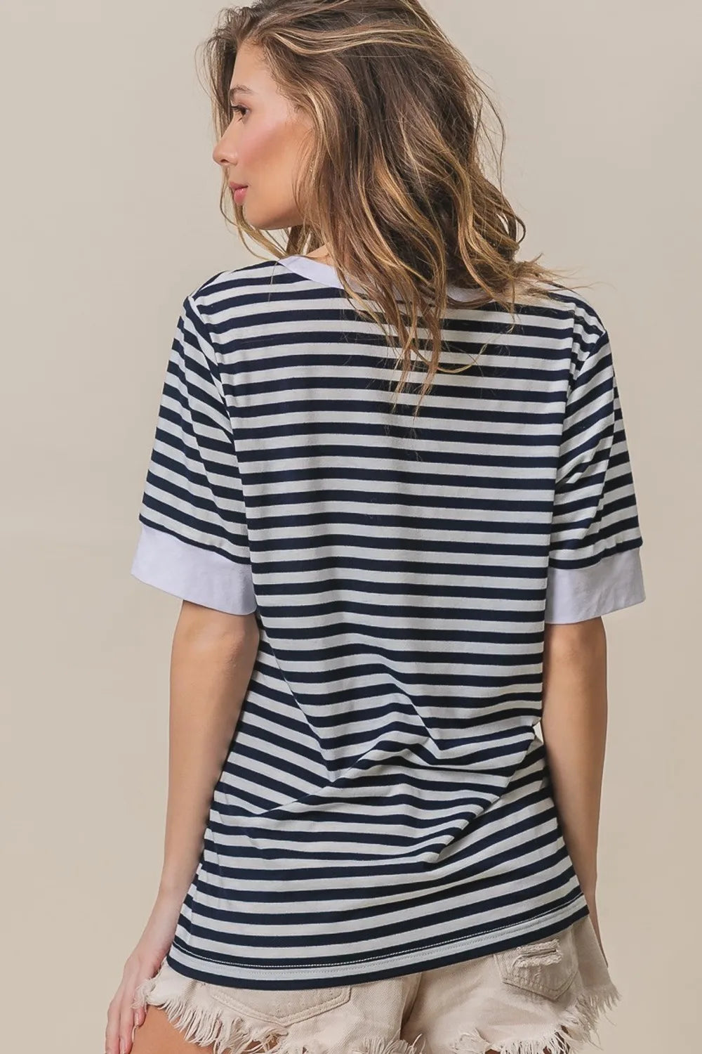 Contrast striped notched knit top, navy and ivory with V-neck and cuffed short sleeves.