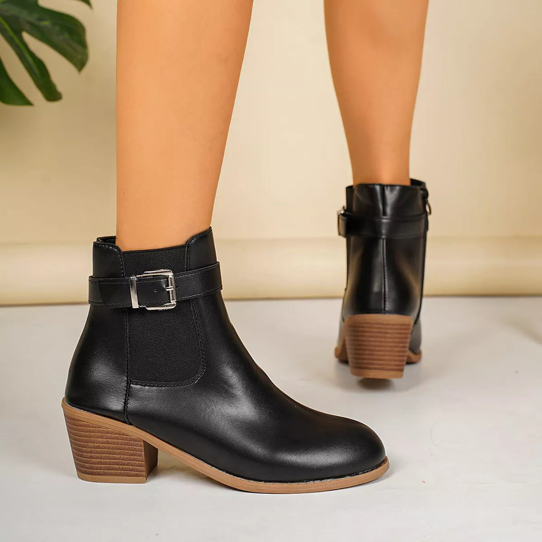 Point-toe block heel boots in black with ankle strap and chunky block heel
