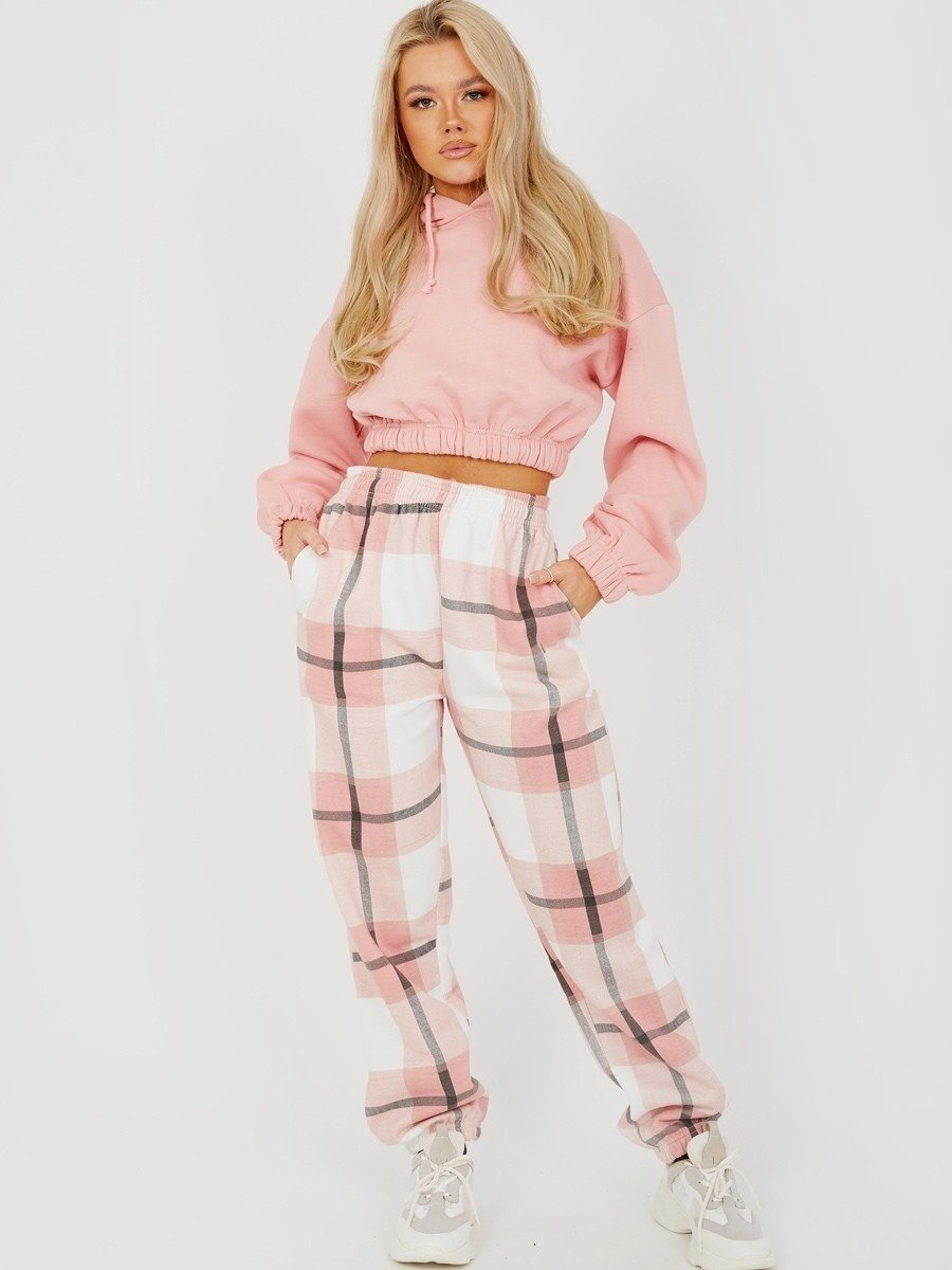 Light pink checked joggers with elastic waist and cuffed ankles.
