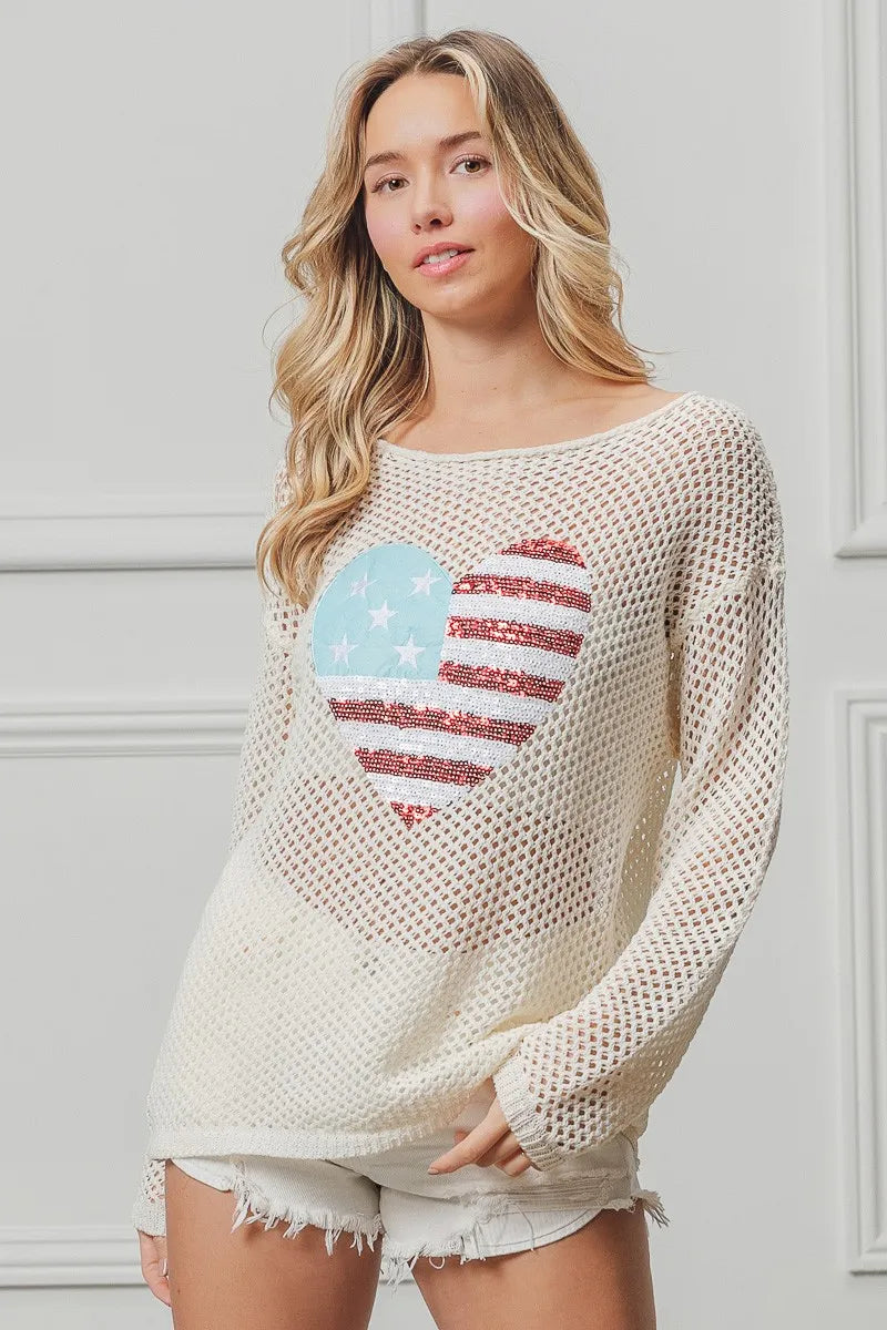 Off-white knit sweater with American flag heart sequin graphic, long sleeves.