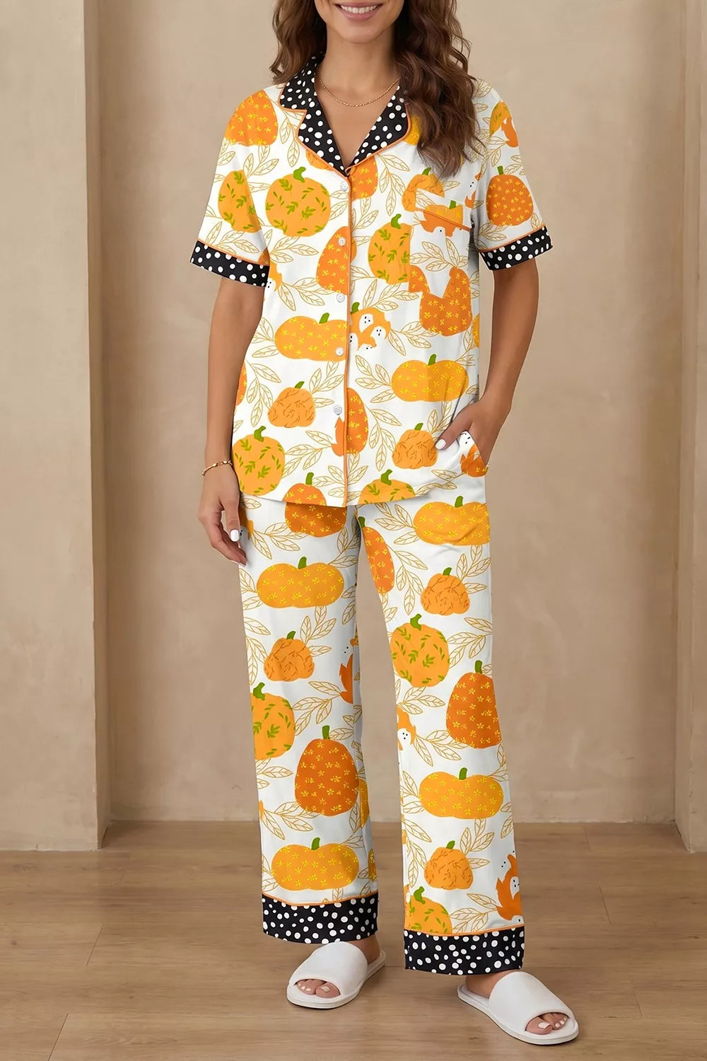 Pumpkin print pajama set with short sleeves and polka-dot trim on cuffs and pant hem