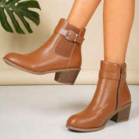 Brown point-toe block heel ankle boots with buckle strap and side zipper