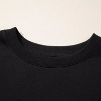 Black crewneck long-sleeve top with ribbed neckline detail