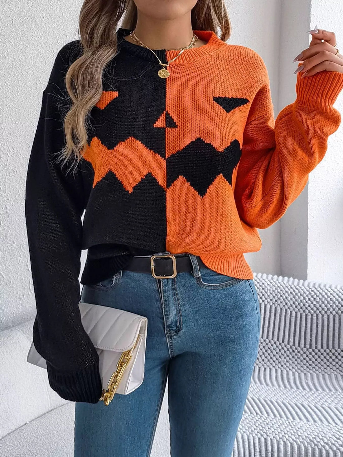Two-tone pumpkin face graphic sweater, orange/black zip-front knit, long sleeves