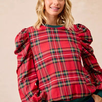 Red plaid blouse with exaggerated shoulders, puff sleeves, and green ribbed trim