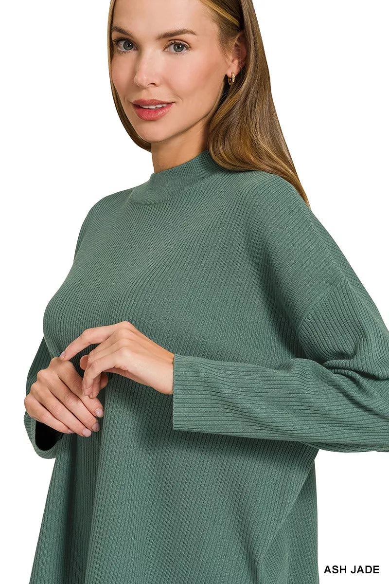 Teal-green crew-neck sweater top with long sleeves and ribbed cuff detail