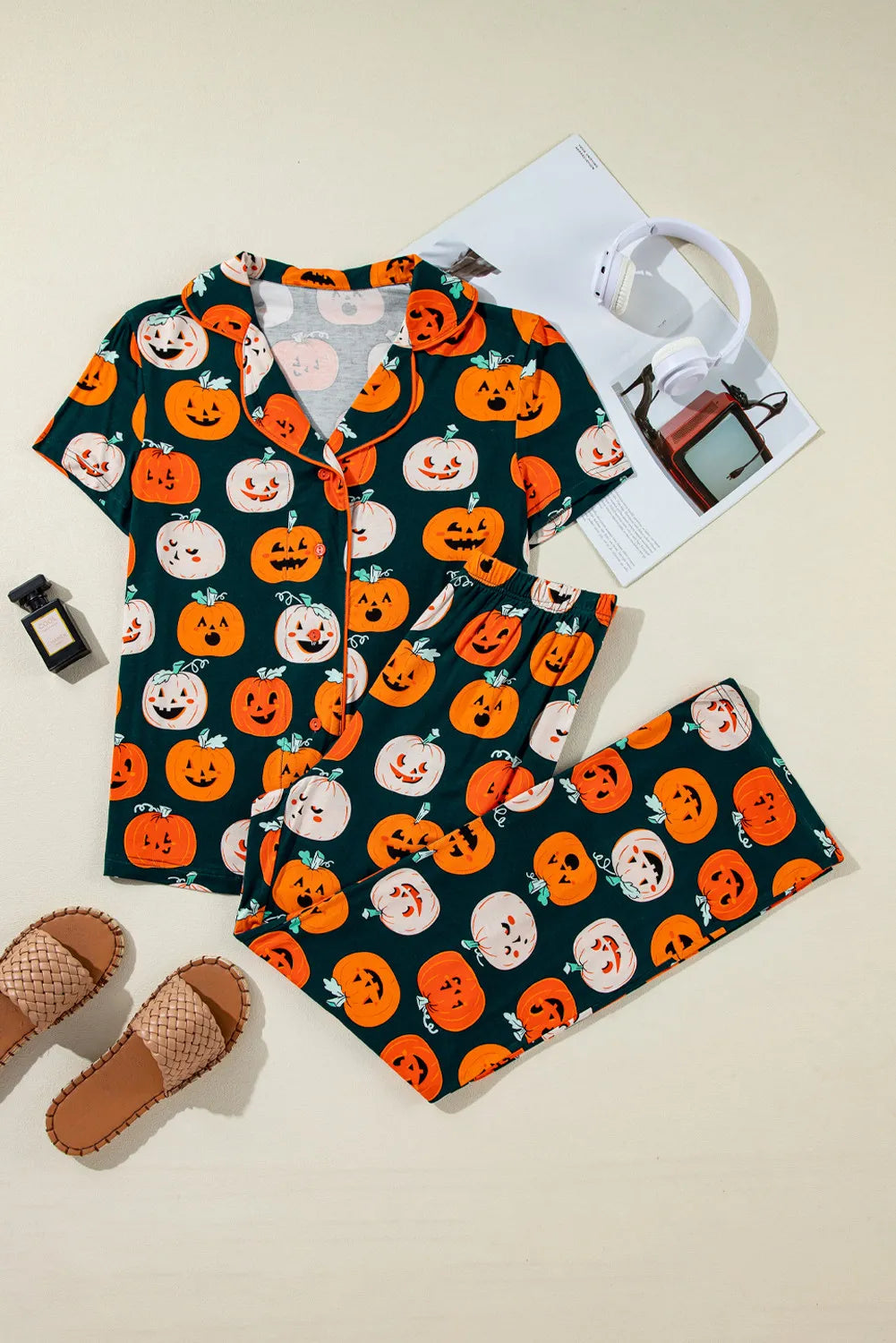 Flat lay of dark green pumpkin-printed short-sleeve top and lounge pants set