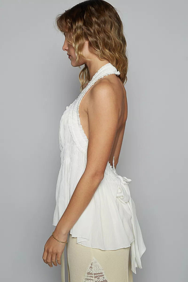 Off-white sleeveless halter top with smocked shirring and ruffle side trim