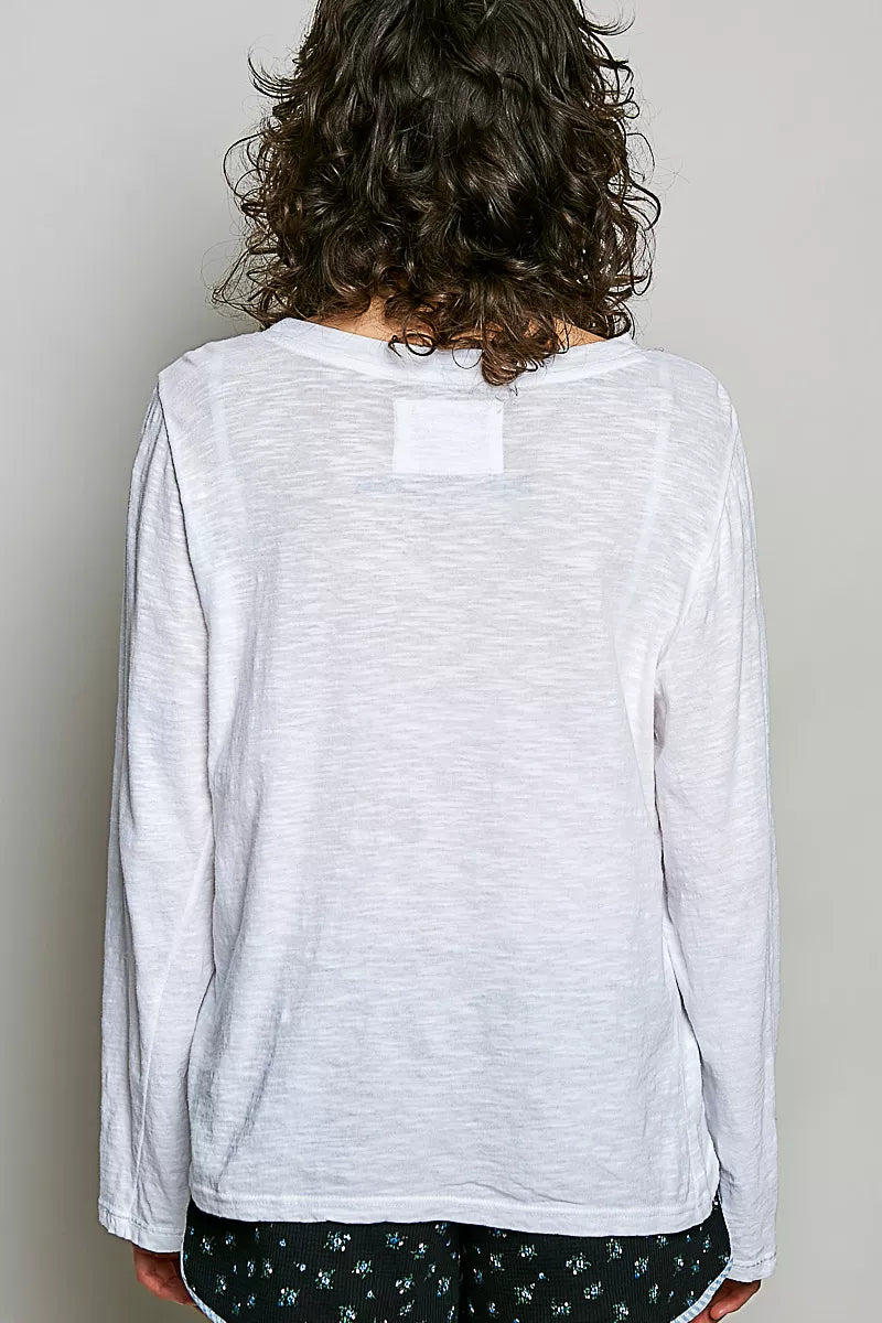 Off white long-sleeve knit top from back view with center yoke patch.