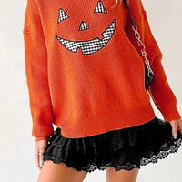 Orange drop-shoulder sweater with jack-o-lantern print and round crew neck