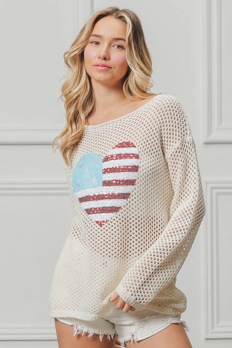 Off-white sequin knit sweater with American flag heart design, long sleeves.