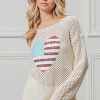 Off-white sequin knit sweater with American flag heart design, long sleeves.