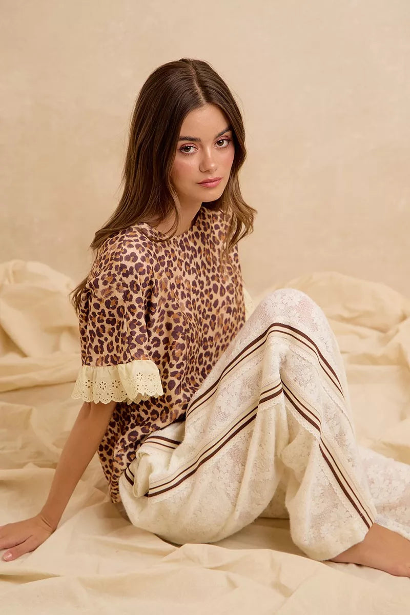 Leopard print ruffled top with eyelet lace hem and puff sleeves