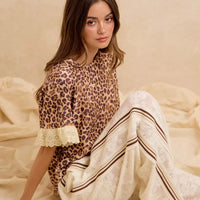 Leopard print ruffled top with eyelet lace hem and puff sleeves