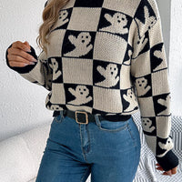 Ghost-pattern checkered round-neck sweater in black and cream with crew neckline.