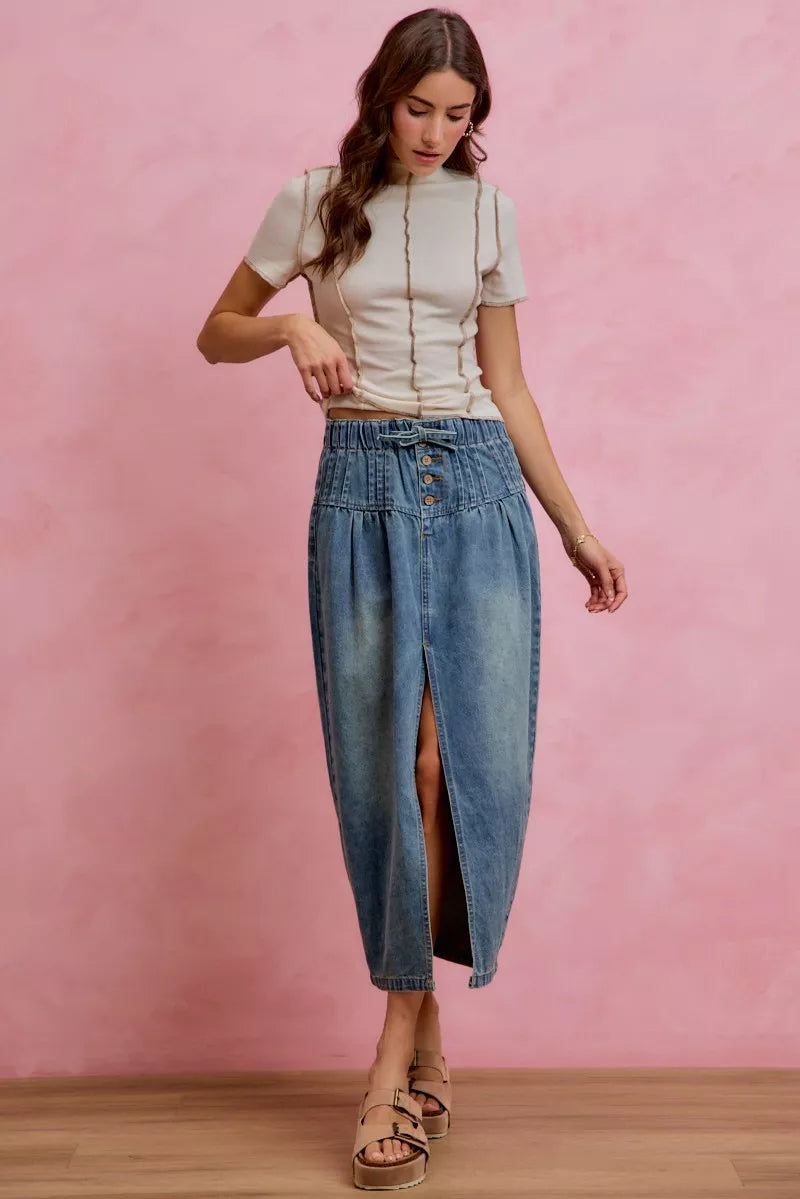 Washed denim midi skirt with front slit and button waistband, side view