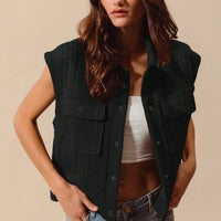 Black knit button-up vest with cable quilt stitching and two flap chest pockets