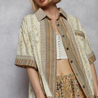 Cream patchwork button-down shirt with chest pocket, short sleeves, dark button front