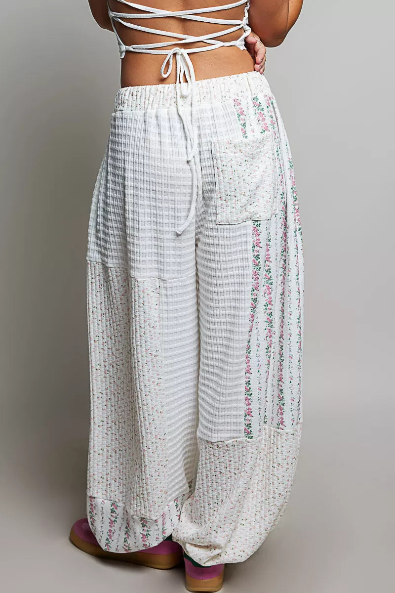 Ivory patchwork knit wide-leg pants, tied drawstring and flowing wide pant legs