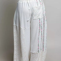 Ivory patchwork knit wide-leg pants, tied drawstring and flowing wide pant legs