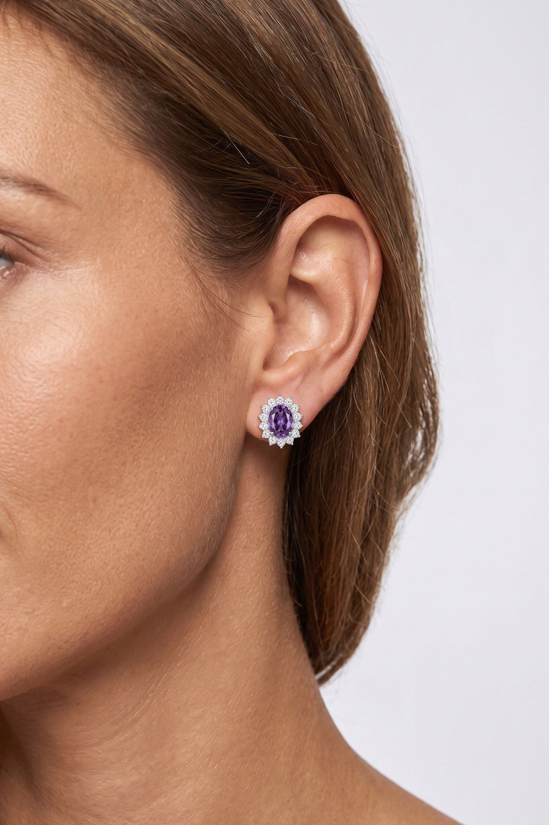 Amethyst flower-shaped stud earrings with small crystal border, silver tone