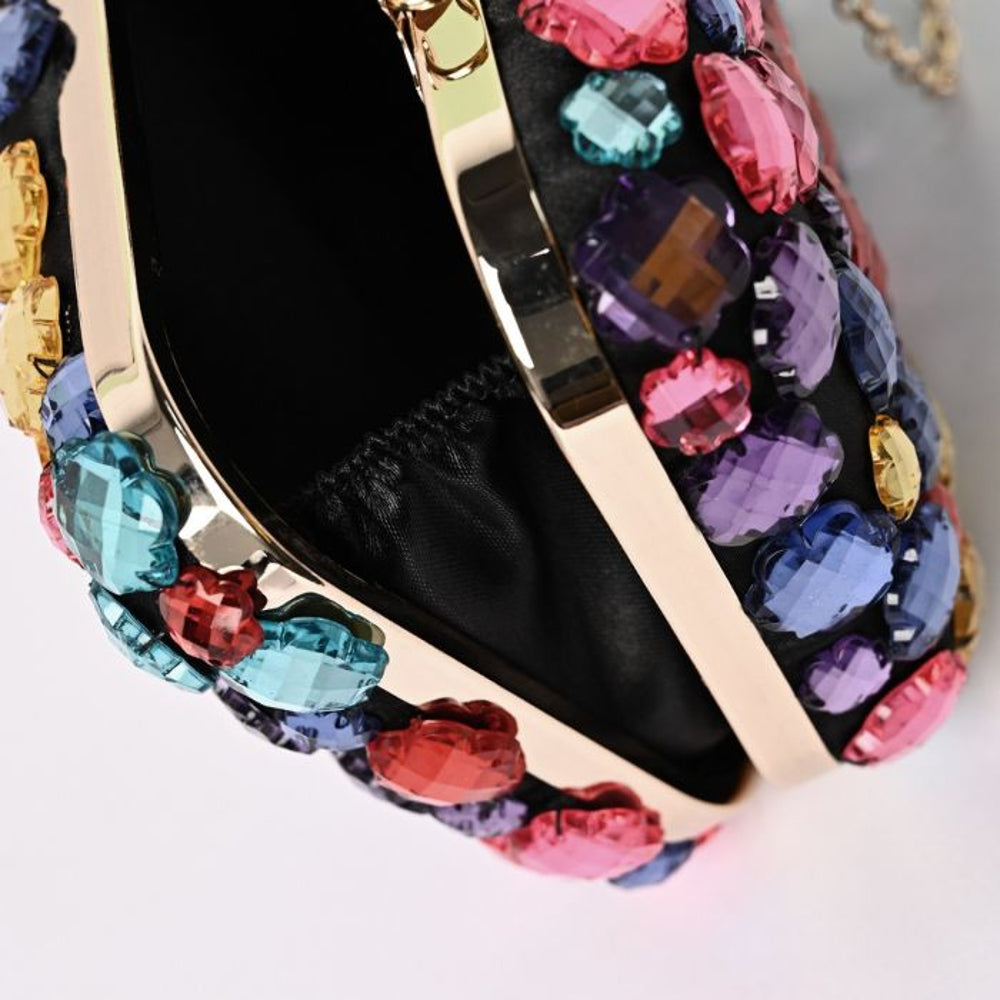 Crystal clutch bag open, showing black interior and gold-tone frame