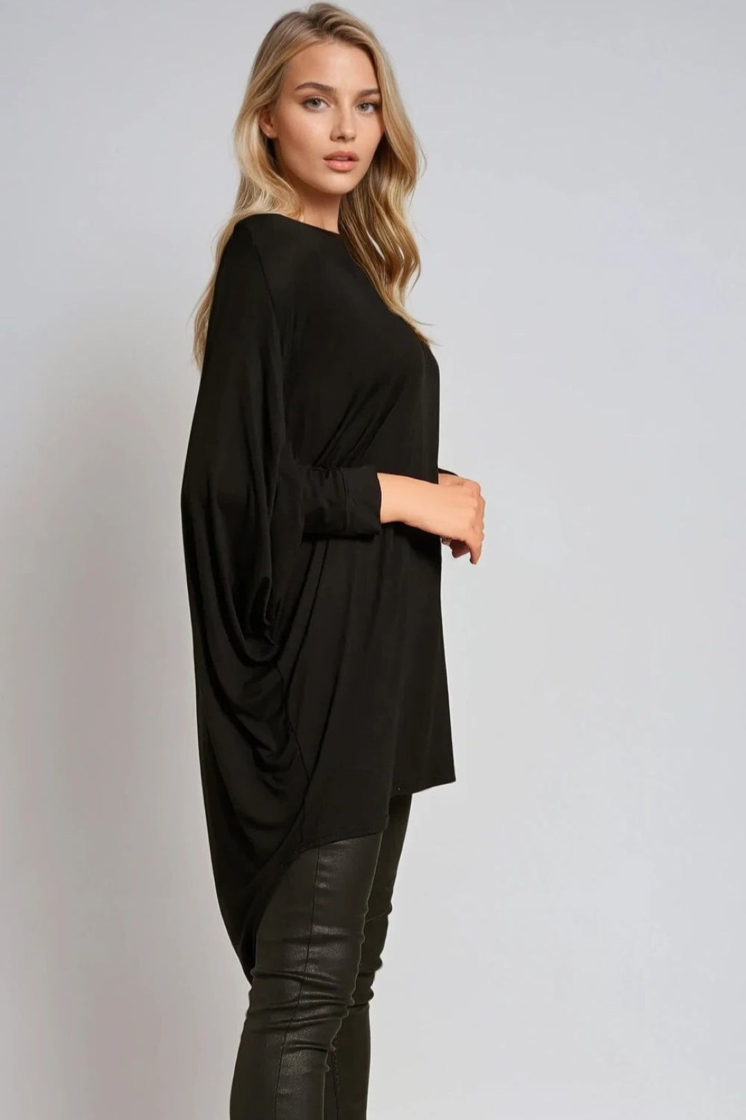 Oversized black batwing top with draped sleeves and high-low hem