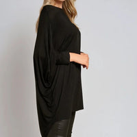 Oversized black batwing top with draped sleeves and high-low hem