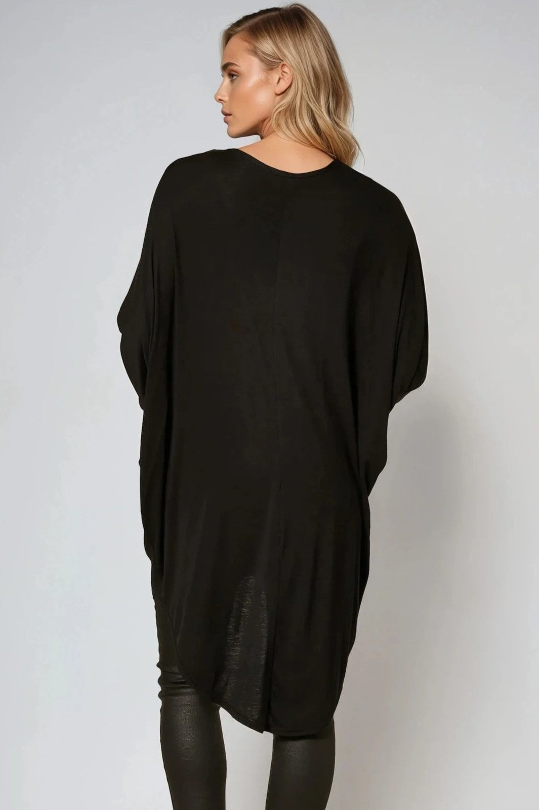 Back view of oversized black batwing top with high-low hem and long drape