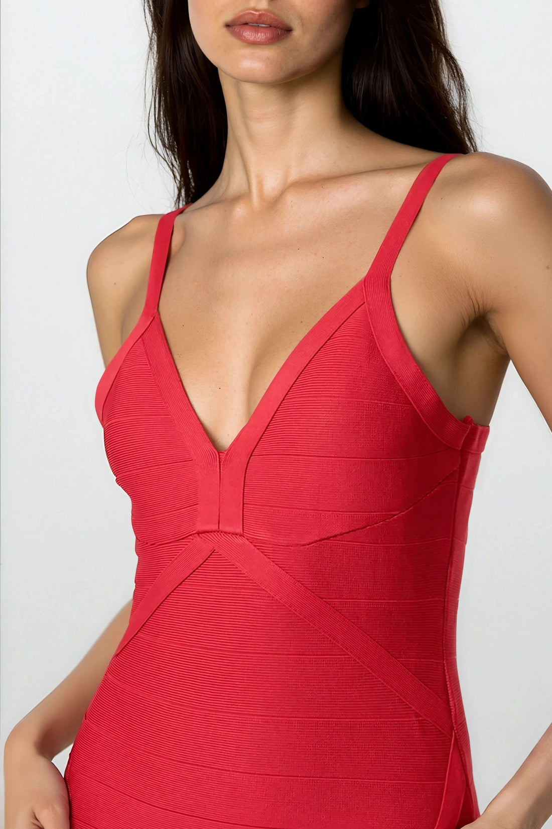 Red bandage dress with deep V-neck and thin straps, contoured seam panels