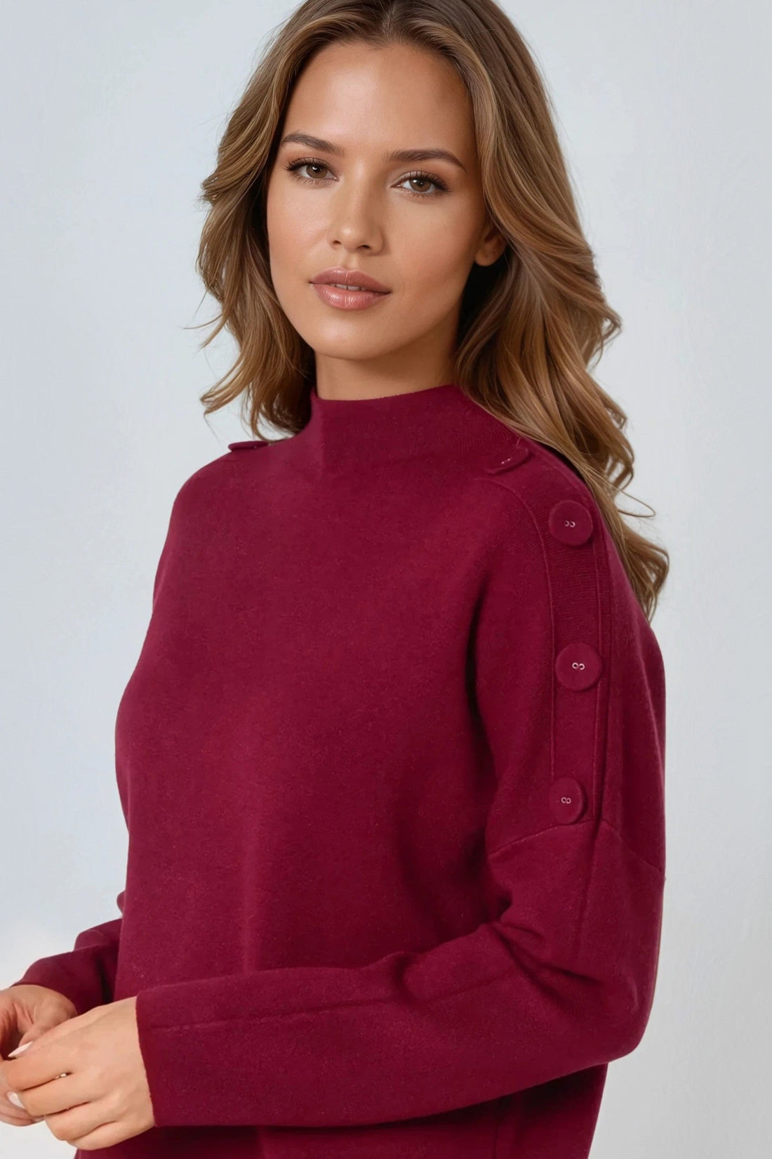 Wine red high-neck jumper with shoulder buttons, neckline and cuff close-up