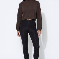Black leggings with wide waistband and smooth front seams.