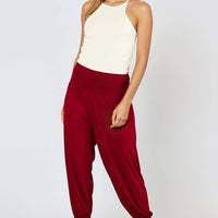 Wine harem trousers with elastic waist and cuffed ankle hems