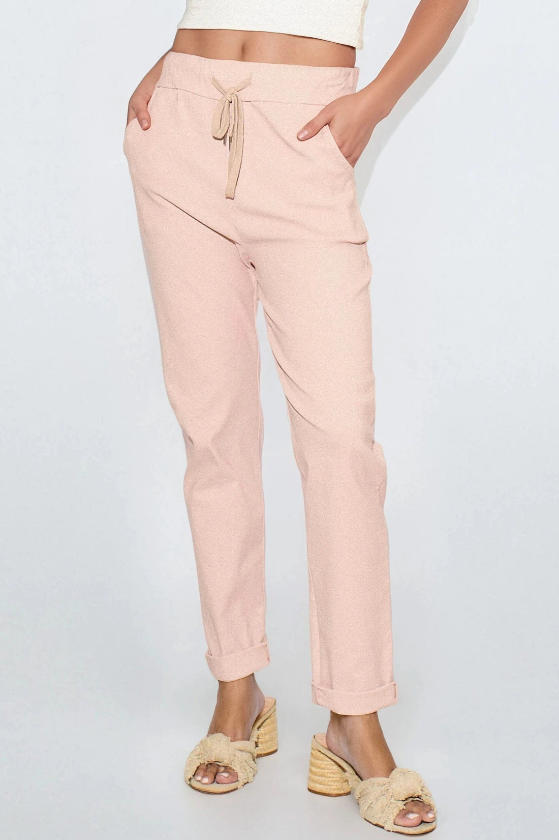 Dusty pink drawstring waistband trousers with side seam pockets and ankle cuffs