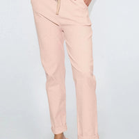 Dusty pink drawstring waistband trousers with side seam pockets and ankle cuffs
