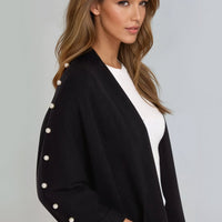 Black open-front cardigan with pearl-embellished sleeve and three-quarter sleeves