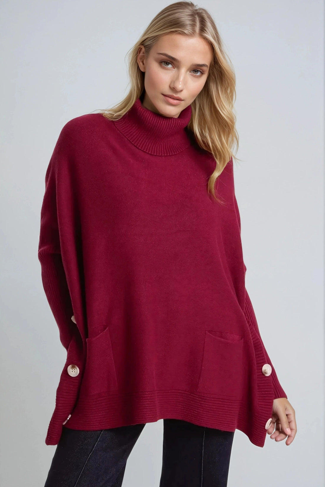 Burgundy roll-neck poncho jumper with side buttons and ribbed cuffs