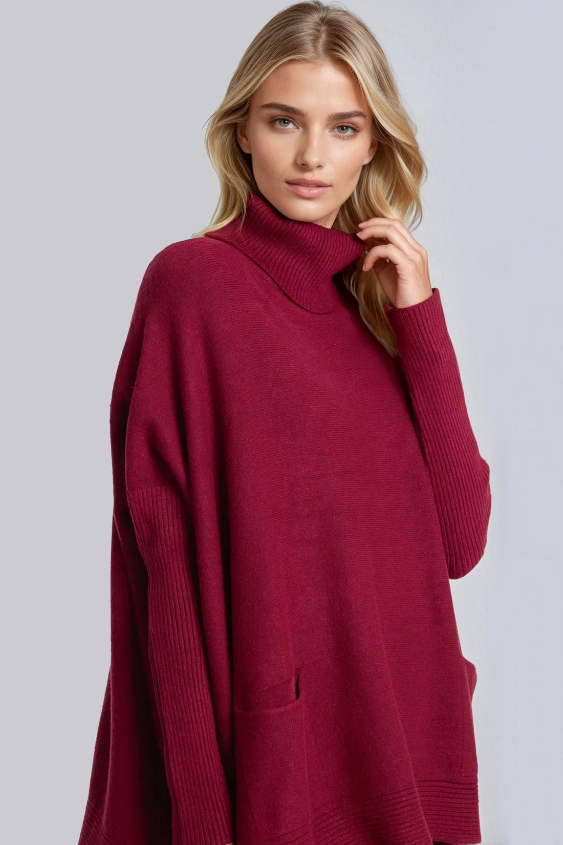 Burgundy roll-neck poncho jumper with ribbed high collar and front pocket