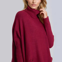 Burgundy roll-neck poncho jumper with ribbed high collar and front pocket
